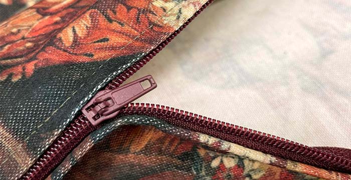 Throw pillow cover close-up of a zipper half opened