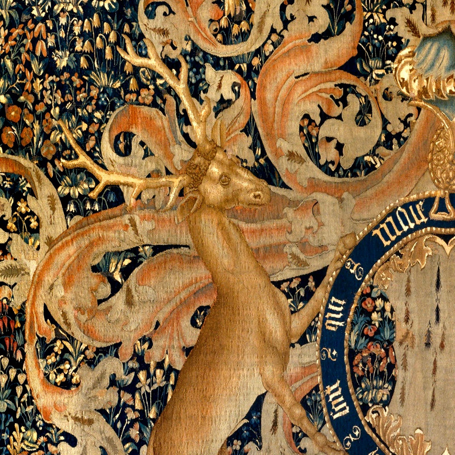 Heraldic deer facing left, richly decorated background with floral motifs and scrollwork.