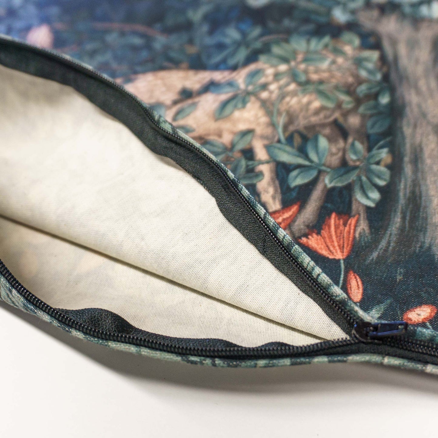 Open zipper detail of the William Morris Greenery cushion cover revealing fabric interior and cover construction.