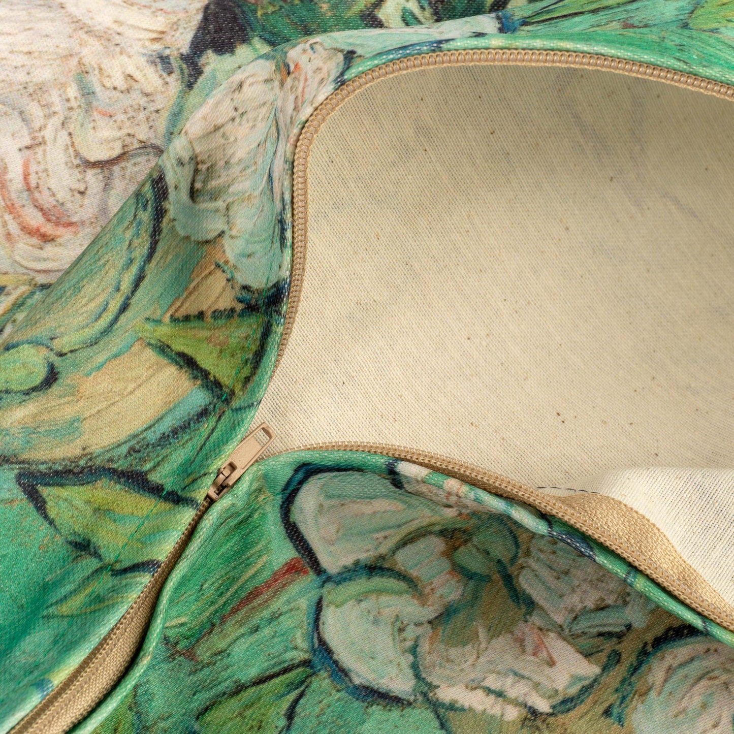 Detail of floral painting pillow cover, showing hidden zipper and natural cotton fabric backing.