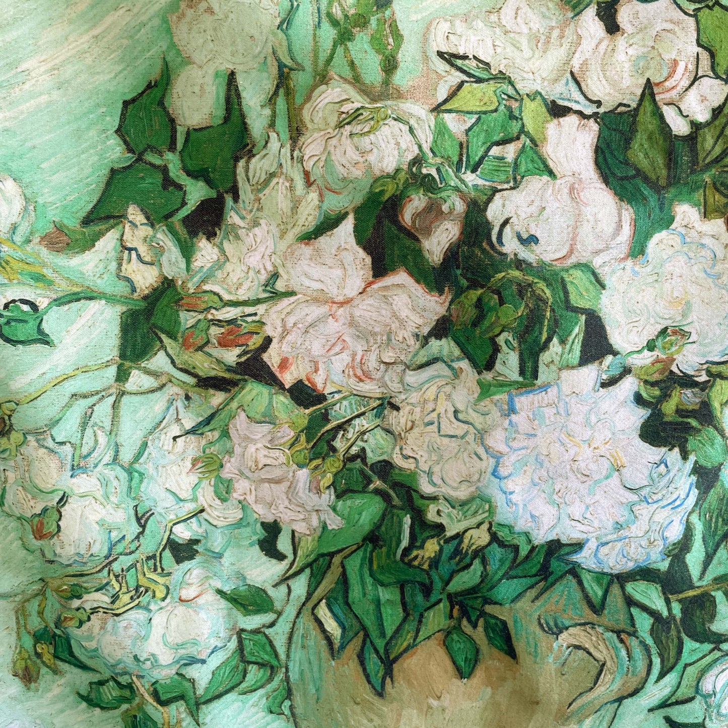 Zoomed-in section of white roses and green leaves from Van Gogh’s “Roses” painting printed on fabric.