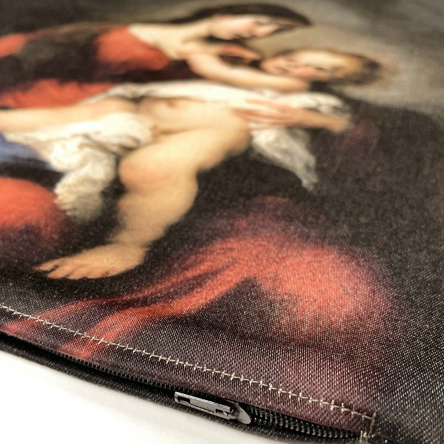 Close-up of Virgin and Child throw pillow cover, showing the black zipper.