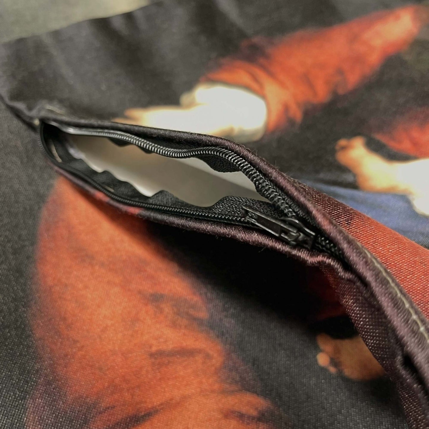 Close-up of Virgin and Child throw pillow cover, showing the black zipper opened