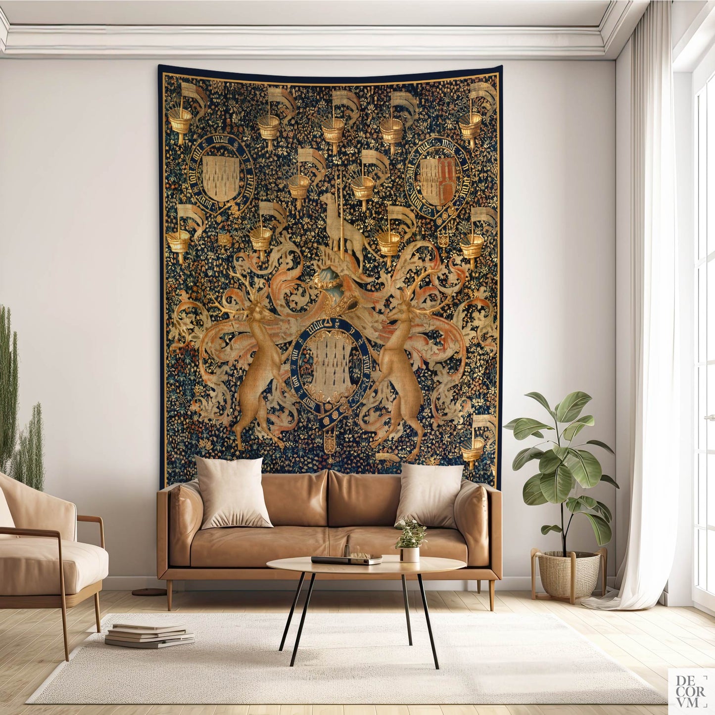 Medieval-style tapestry with intricate coat of arms design, shown in a warm-toned living room with leather sofa.