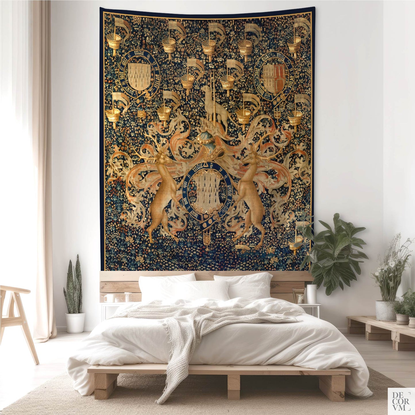Large wall tapestry with armorial badges and floral background, styled in a soft, light-filled bedroom.