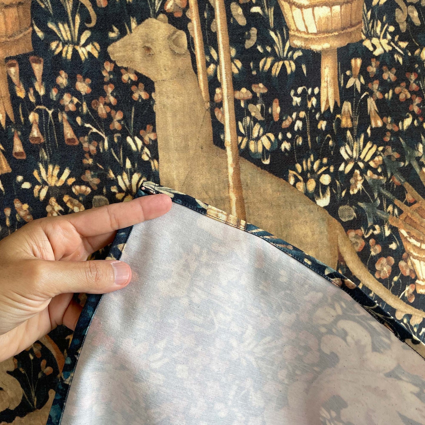 Close-up of the back and edge stitching of the Armorial Bearings tapestry, showing fabric texture and detailed finish.