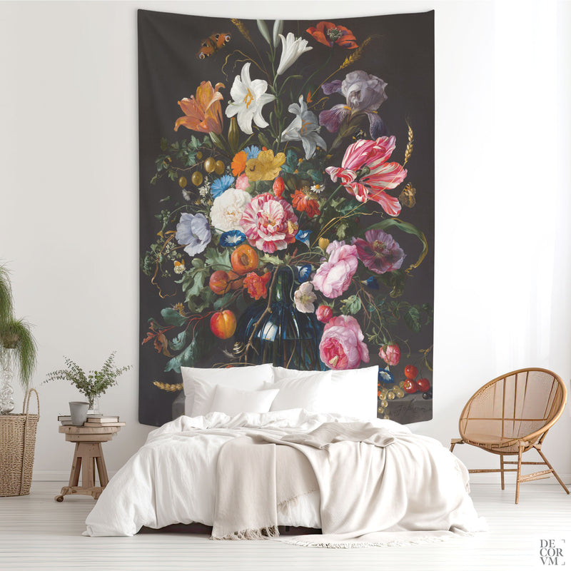 Large Dutch Floral Still Life wall tapestry hung above a bed in a moody bedroom — baroque bouquet with peonies, tulips, and a deep blue glass vase.
