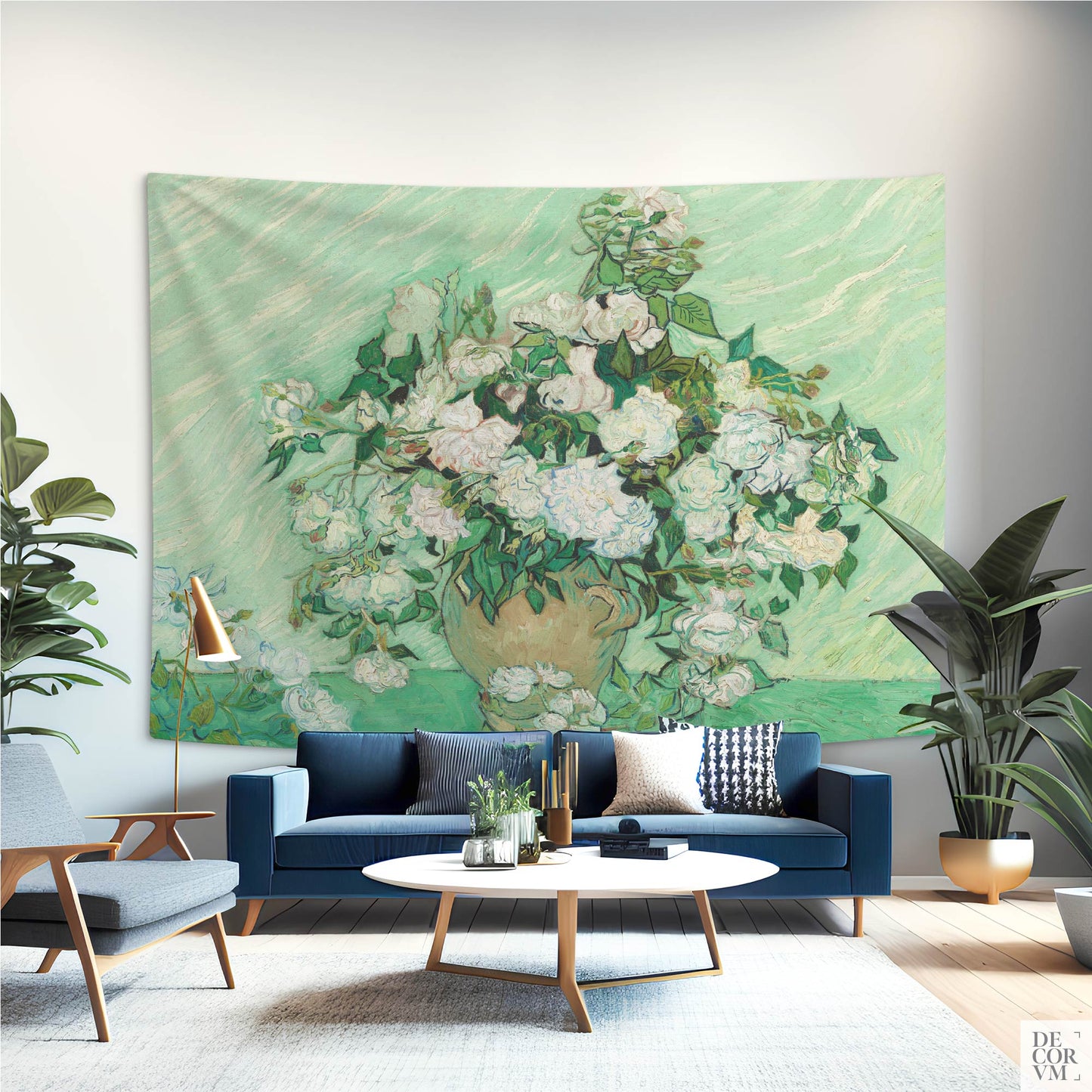 Van Gogh floral tapestry with green and white roses displayed behind a navy blue sofa in a contemporary living room.