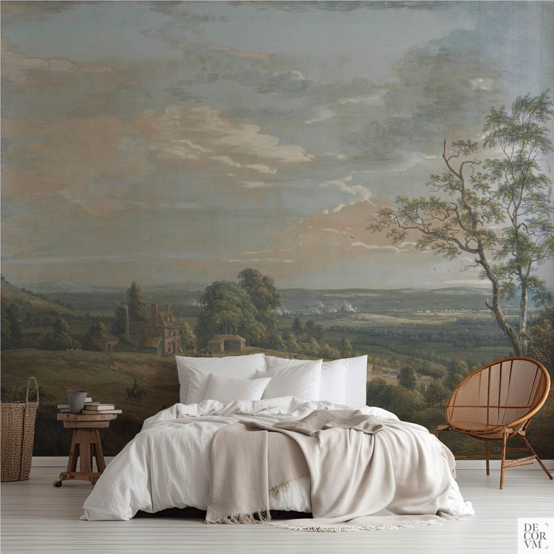 Bedroom with wallpaper mural of an 18th-century English countryside landscape featuring soft clouds and rolling hills, printed by Decorvm