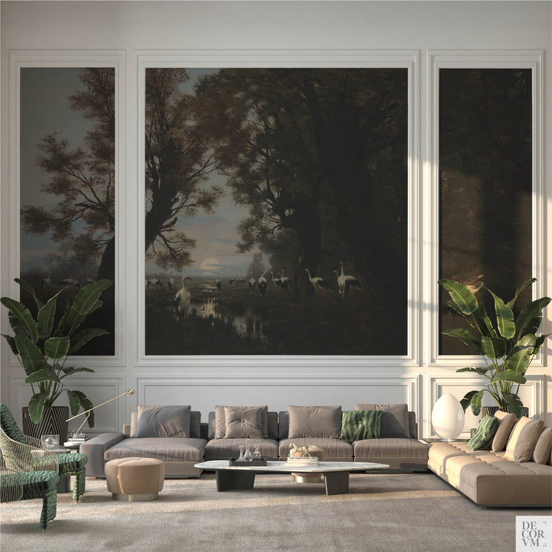 Storks in moonlit marshland wallpaper mural in a classic living room — dark naturalism scene framed in three panels above a sectional sofa by Decorvm