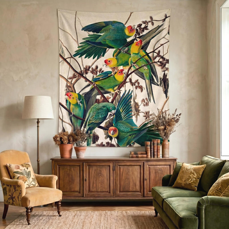 Audubon Carolina Parakeet wall tapestry over a wooden sideboard between a mustard armchair and olive velvet sofa in a warm eclectic living room by Decorvm.