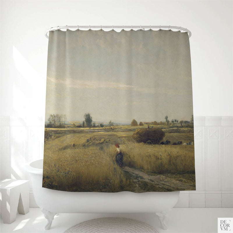Golden wheatfield harvest shower curtain hung over a white clawfoot tub in a bright bathroom — an 1851 French Barbizon landscape by Charles-François Daubigny printed on soft cream fabric by Decorvm.