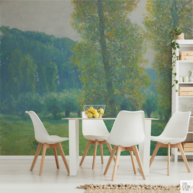 Impressionist poplar meadow wallpaper mural of fresh yellow and turquoise foliage, covering the wall of a bright dining room behind a slim white table with white chairs and a shelving unit by Decorvm.
