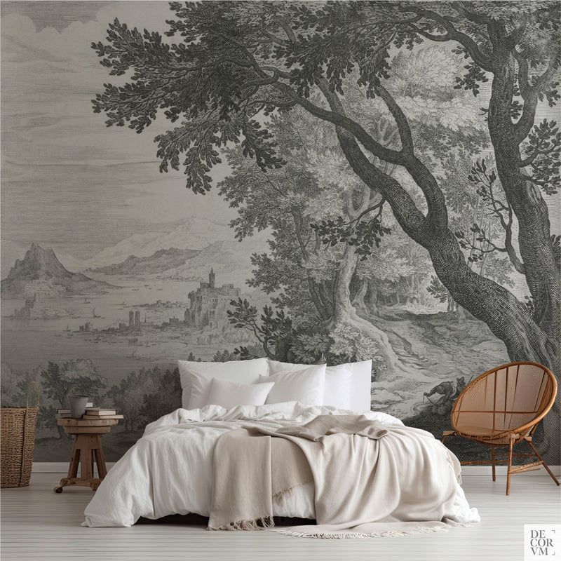 Old Master engraved forest landscape wallpaper mural in neutral gray behind a bed, with castle and river view.