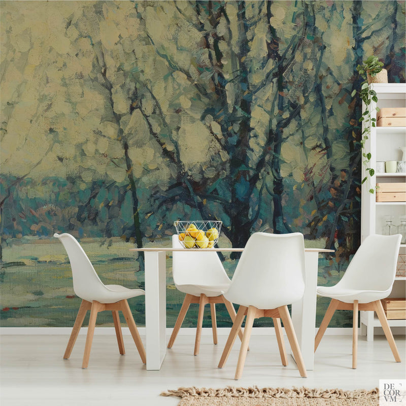 Snowy birch woods wallpaper mural of frosted birches above half-frozen water, covering the wall of a bright dining room behind a slim white table with white chairs and a shelving unit by Decorvm.