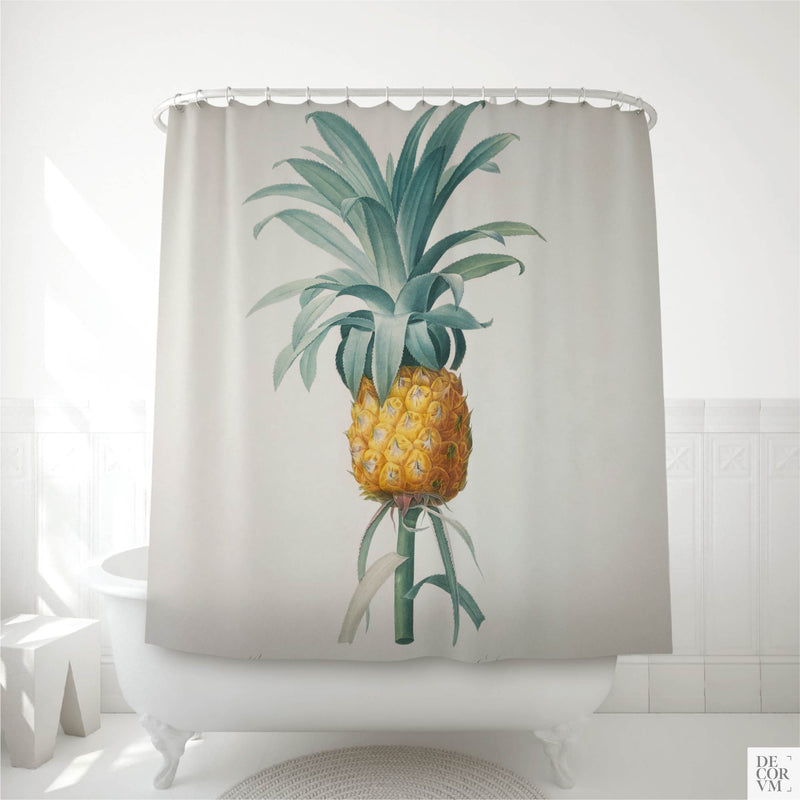 Vintage pineapple shower curtain hung over a white clawfoot tub in a bright bathroom — a 19th-century French botanical print of Bromella ananas printed on soft cream fabric by Decorvm.