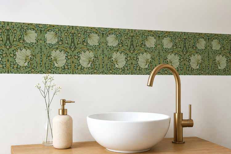 William Morris Pimpernel peel-and-stick wall border in sage above a bathroom vanity with white vessel sink and brass faucet — vintage floral decor by Decorvm
