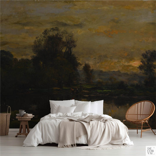 Moody Dusk Landscape Wallpaper Mural in bedroom, dark academia Barbizon dusk with trees and reflective pond behind white bed and rattan chair, custom sized wall art.