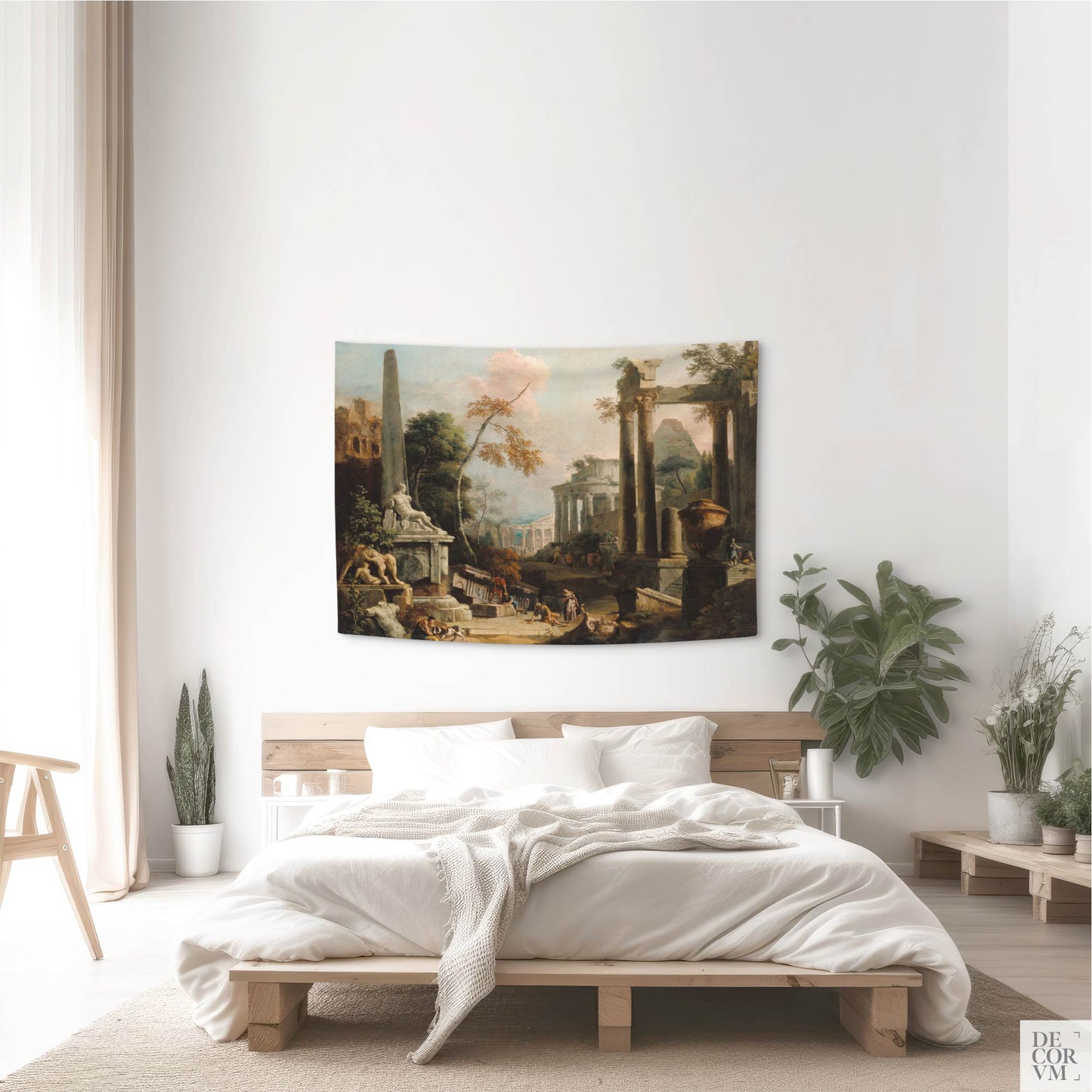 Small-sized wall tapestry depicting classical ruins, displayed in a bright bedroom with indoor plants and natural light.