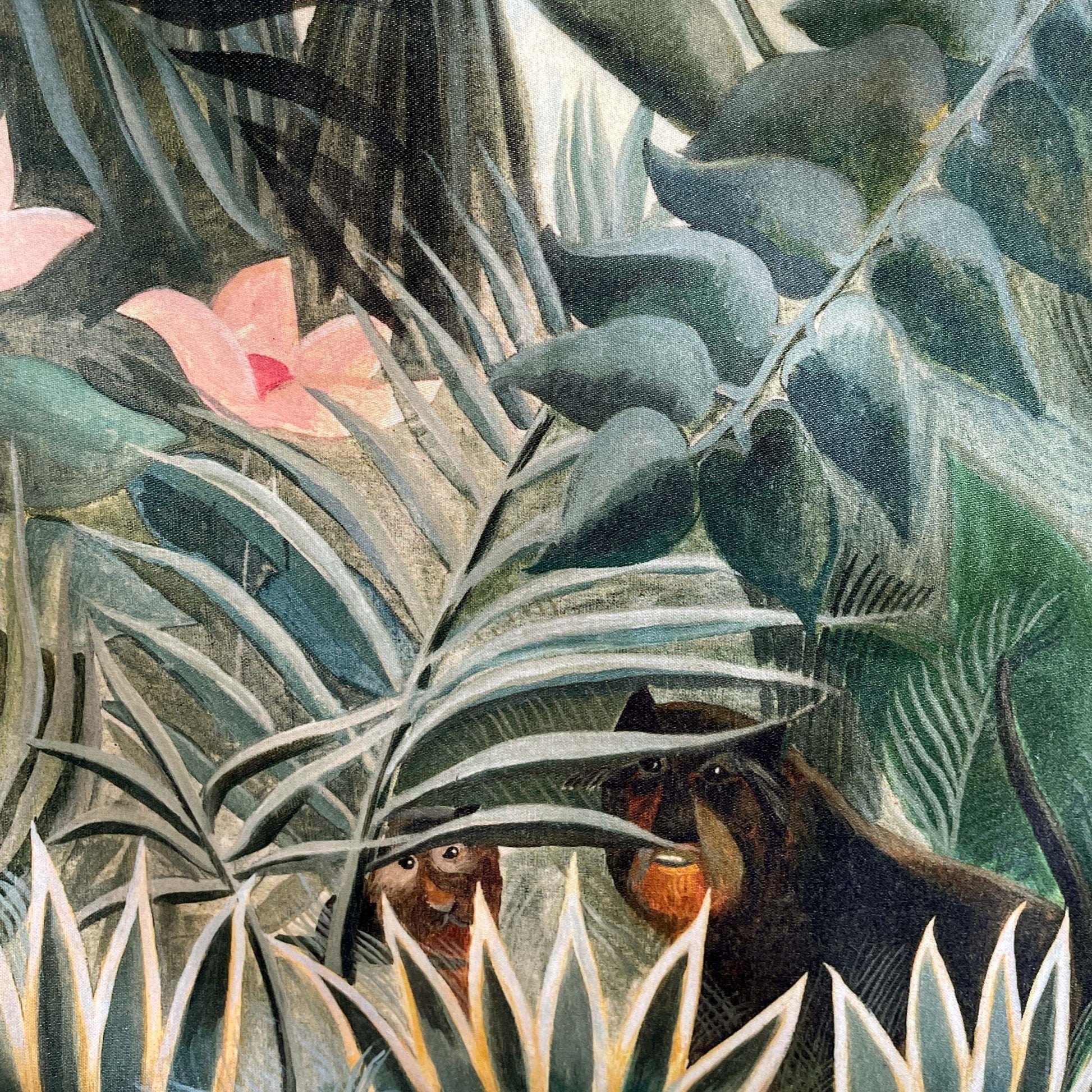 Close-up of the Henri Rousseau Equatorial Jungle cushion cover, showing playful monkeys hiding among lush emerald greenery and pale tropical flowers.