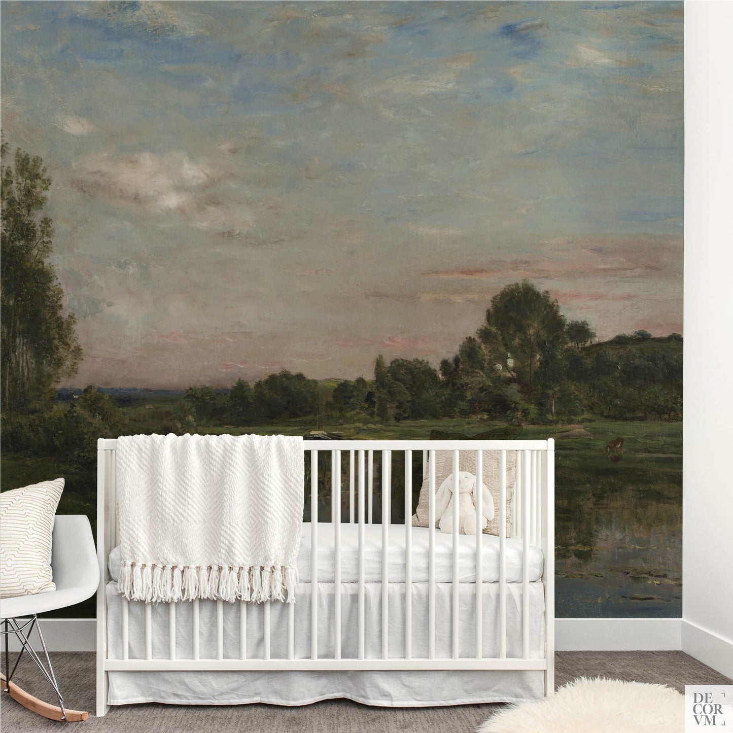 Nursery with white crib and rocking chair using the French River Landscape Wallpaper Mural; serene sky and green riverbank for a soothing, family-friendly backdrop.