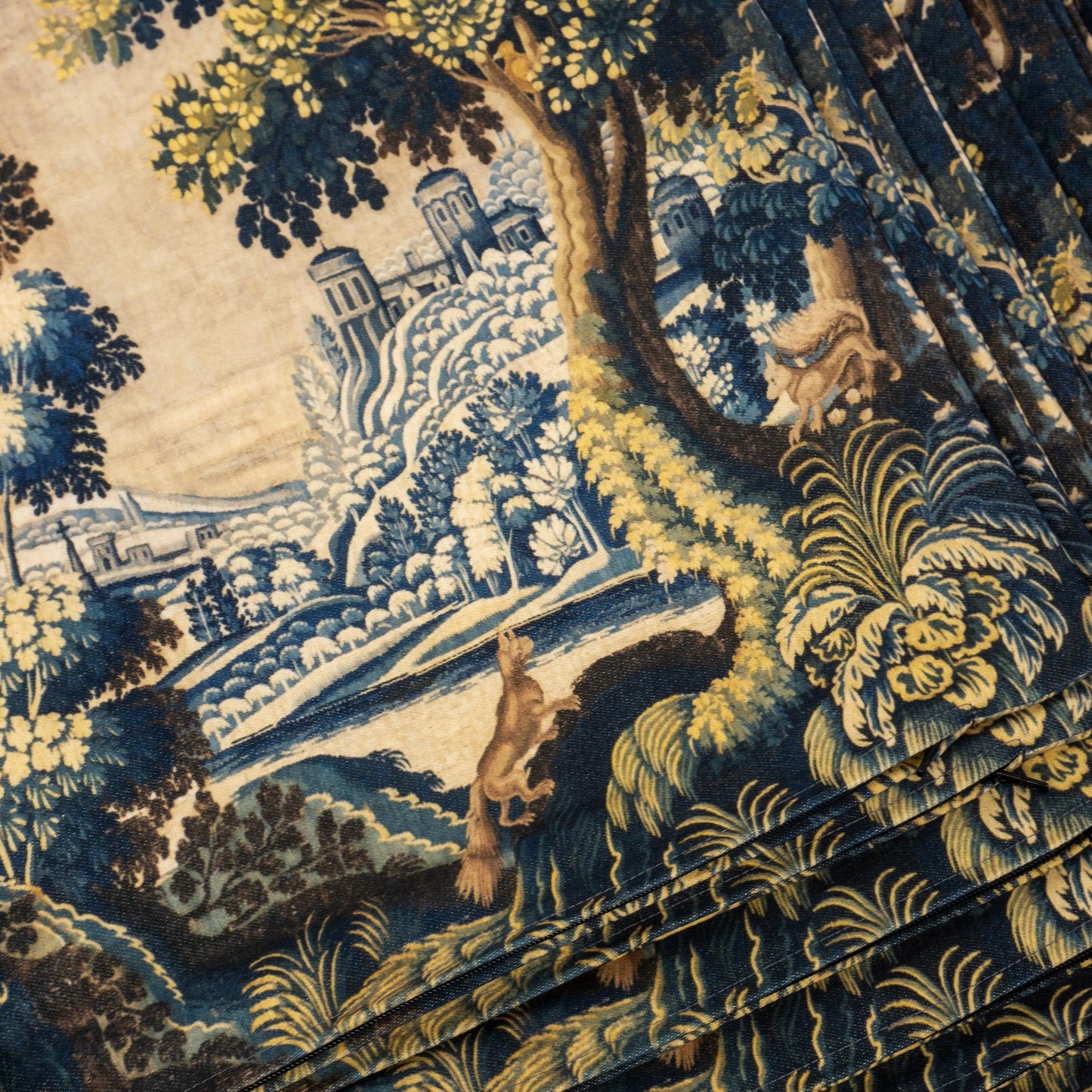 Close up of cushion cover texture showing castle, fox and blue foliage design vintage reproduction by Decorvm