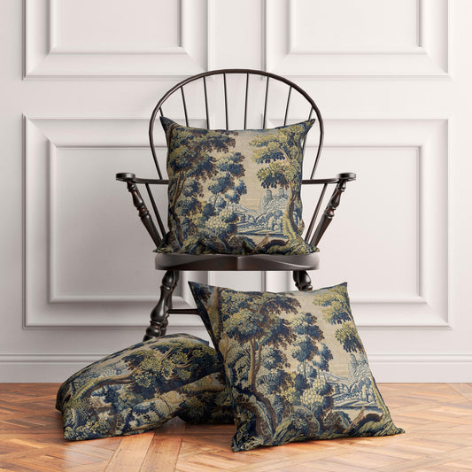 Two French Verdure Forest cushion covers styled on a wooden chair and floor in a dark academia decor scene.