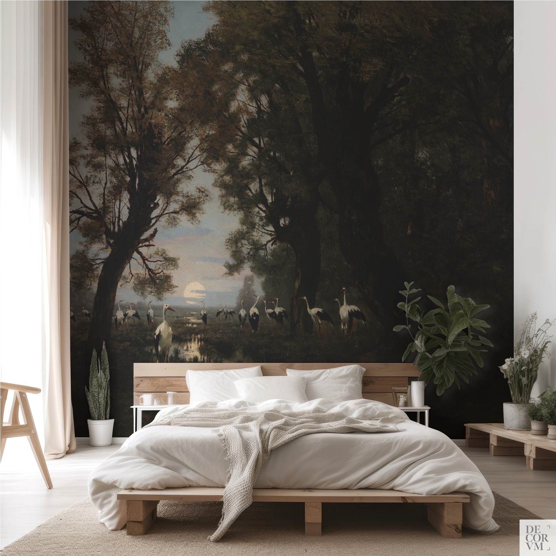 Bright bedroom interior with the Gathering Storks wallpaper mural as an oversized statement wall behind a low wooden bed and neutral linens.