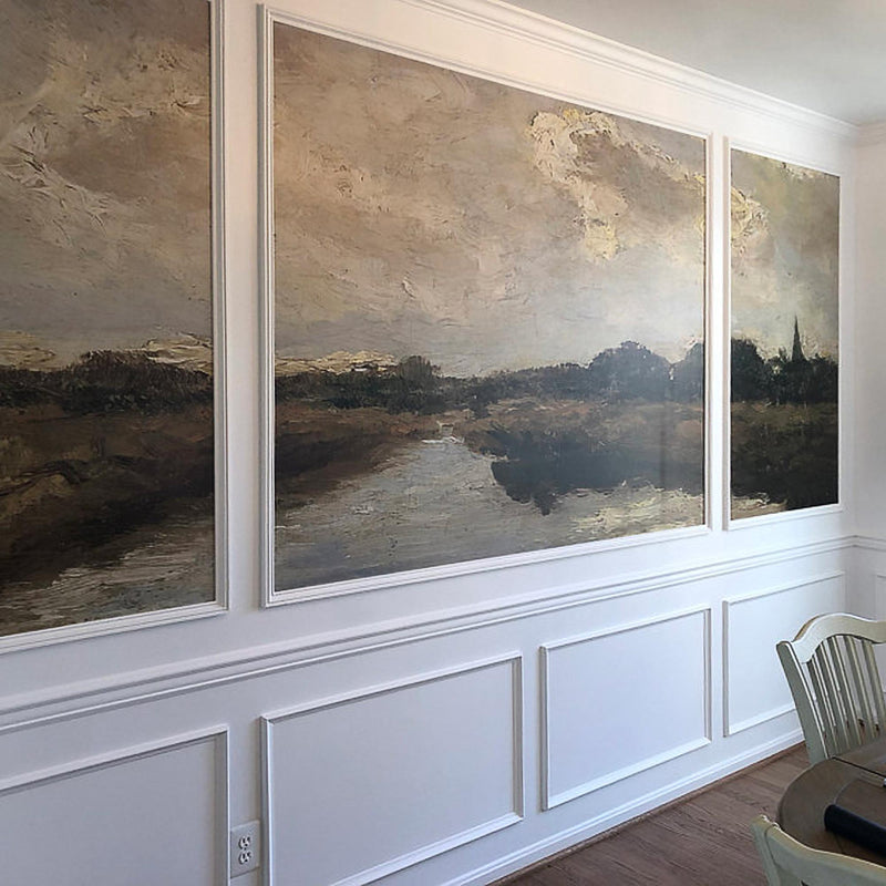 Dutch river landscape wallpaper mural in a dining room — vintage oil painting installed within multiple wall moulding panels