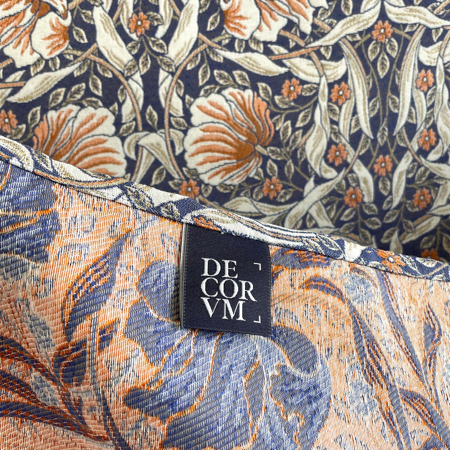 Hem with DECORVM label on the Pimpernel jacquard tapestry, showing two-sided weave and rich colors.