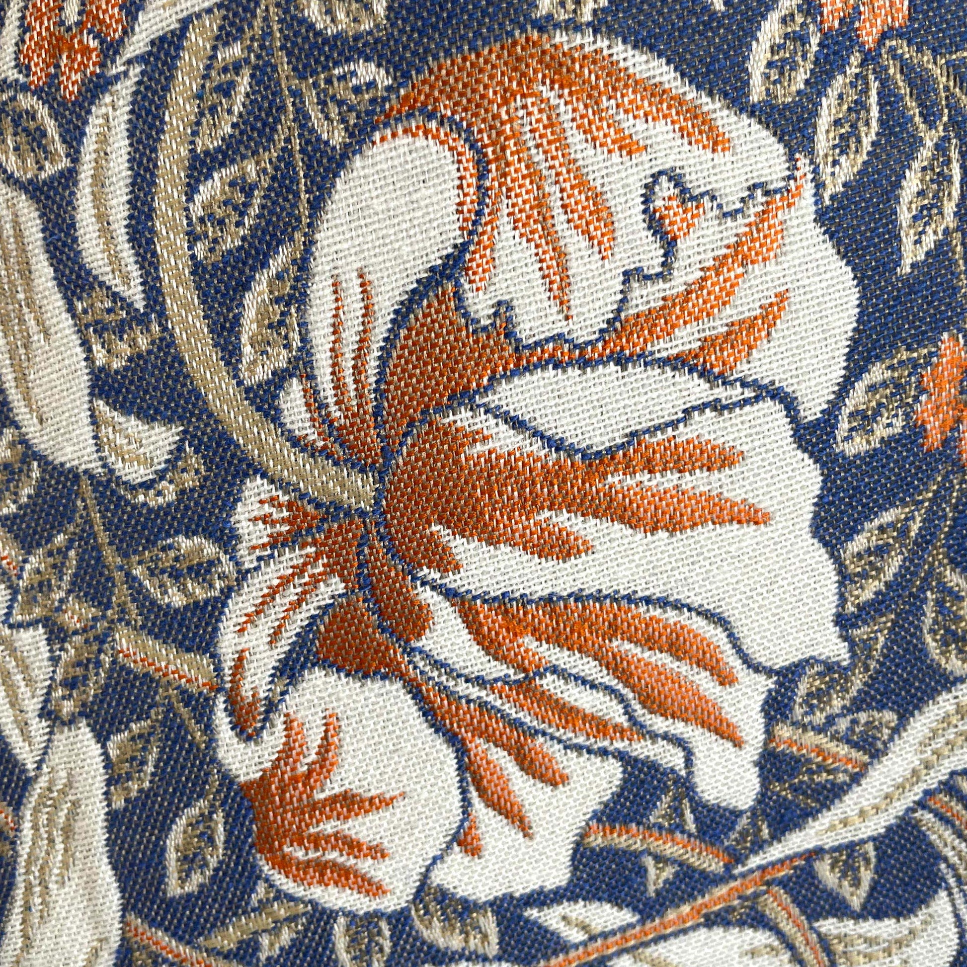 Macro of Pimpernel floral; rust and ivory blossom with olive leaves on deep navy woven jacquard.