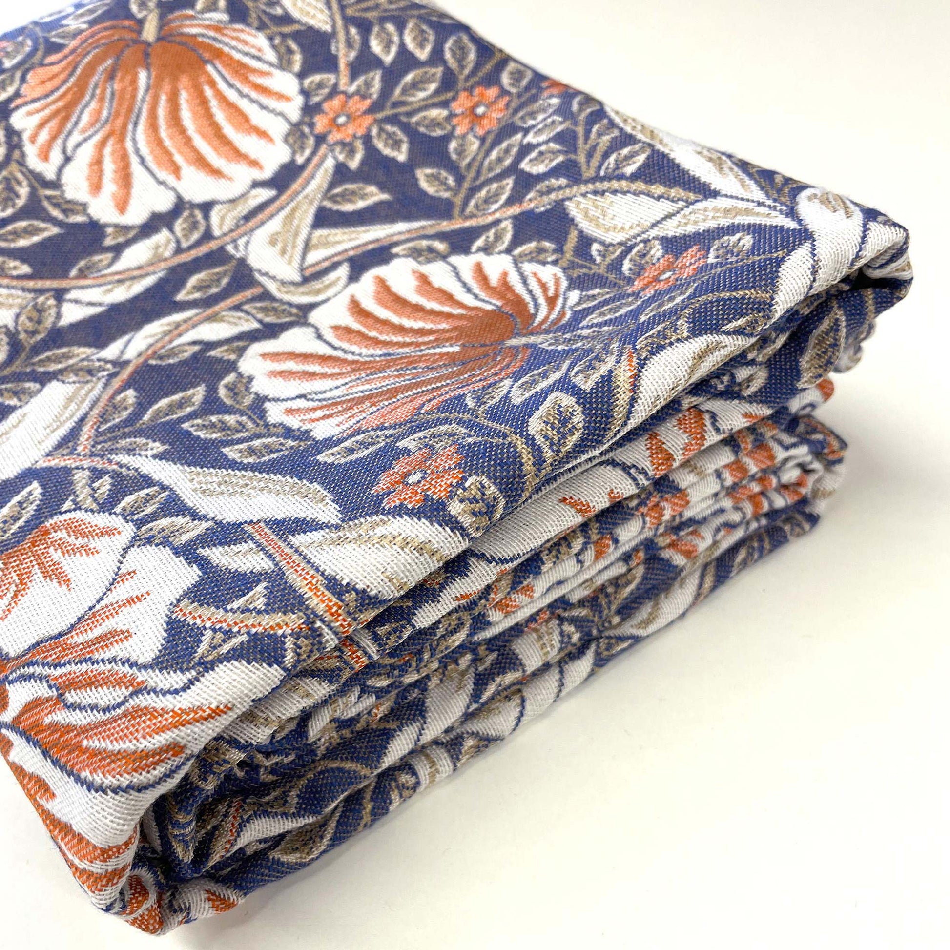 Folded William Morris Pimpernel tapestry highlighting fabric weight, texture and detailed floral repeat.