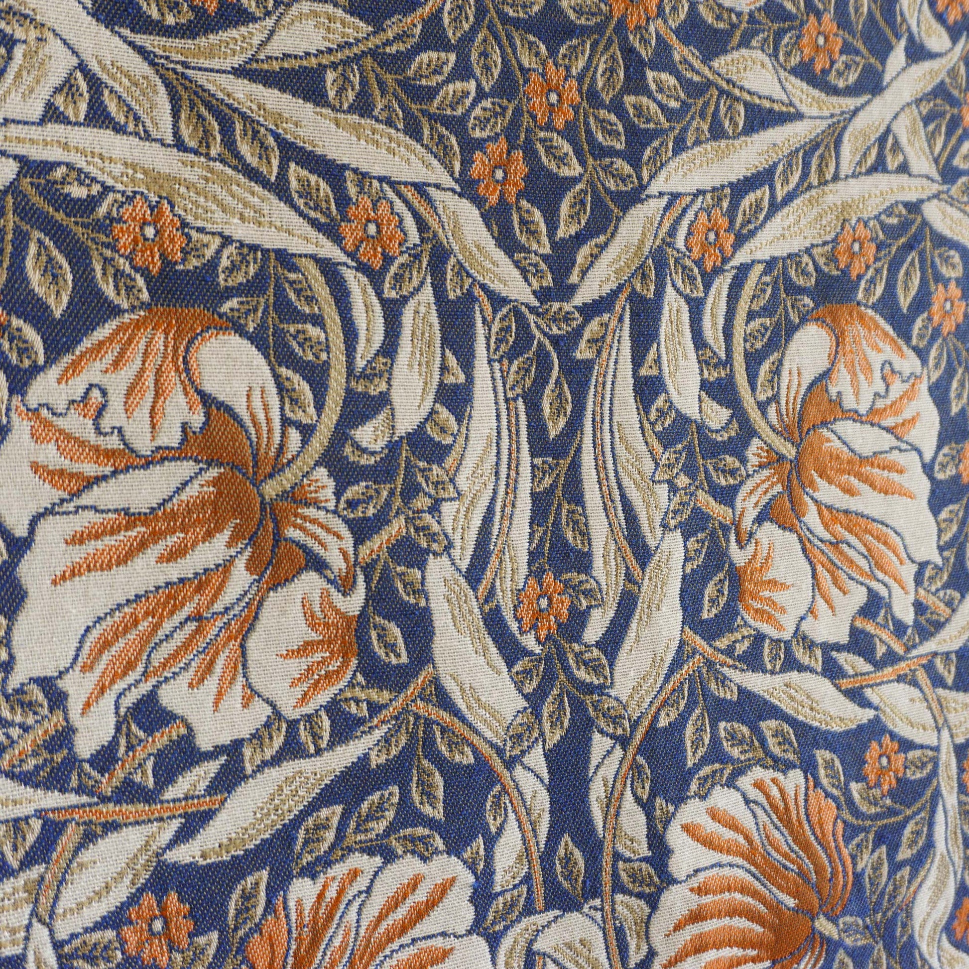 Close detail of Pimpernel tapestry; scrolling foliage and blossoms in a navy, rust and taupe palette.