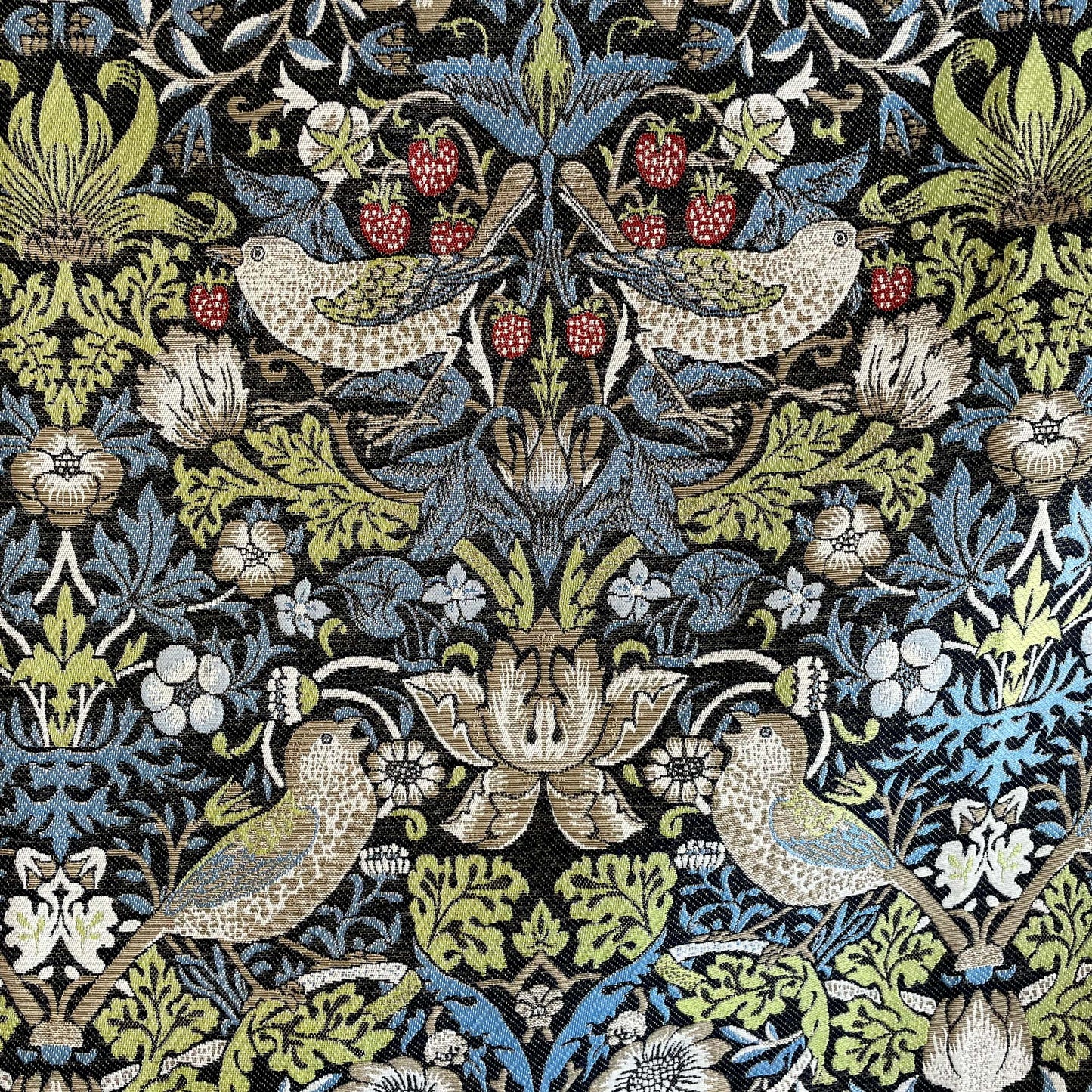 Close view of Strawberry Thief pattern with birds, berries, and foliage in William Morris style, blue sage and taupe palette.