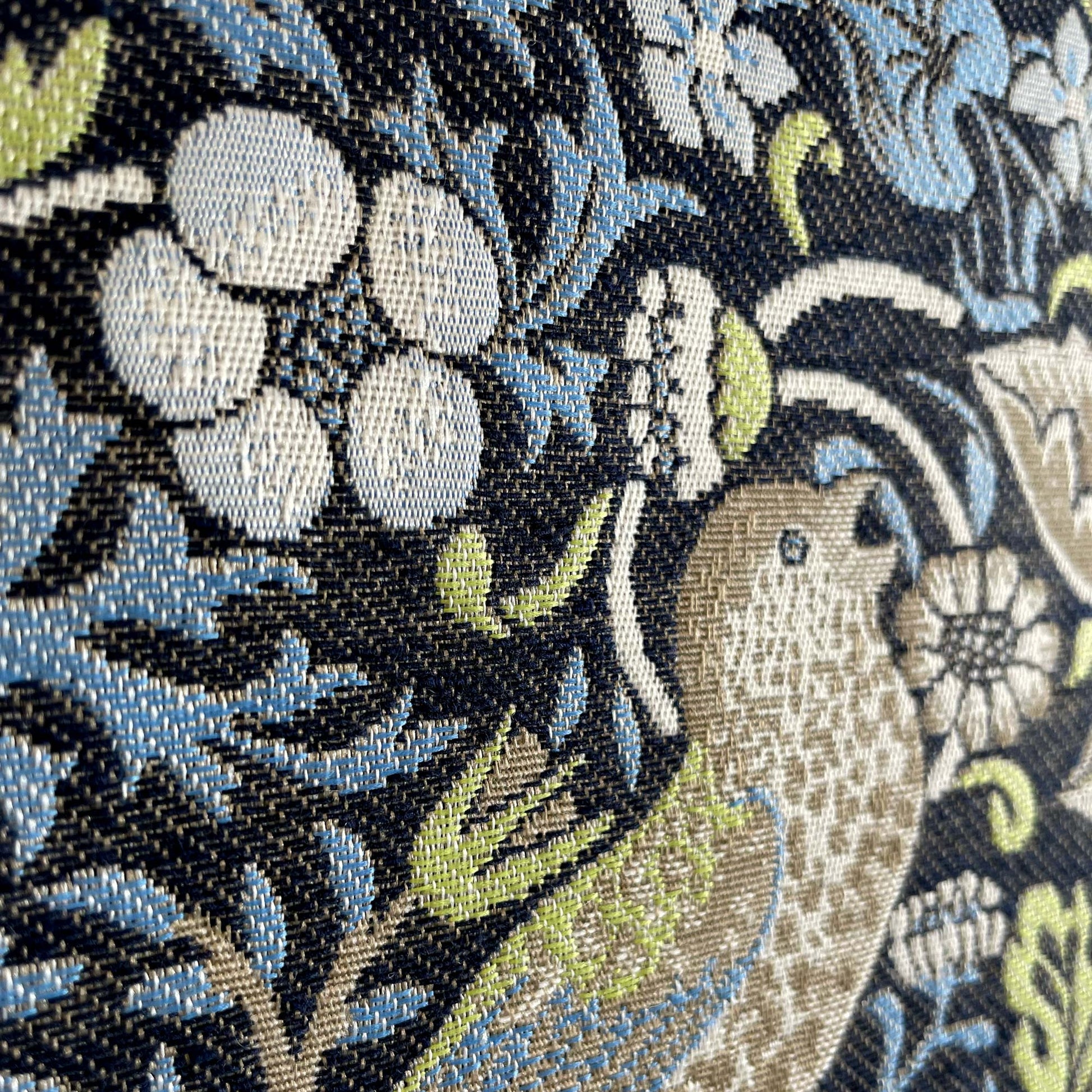 Macro of florals and vines on Strawberry Thief tapestry showing raised weave and crisp pattern definition.