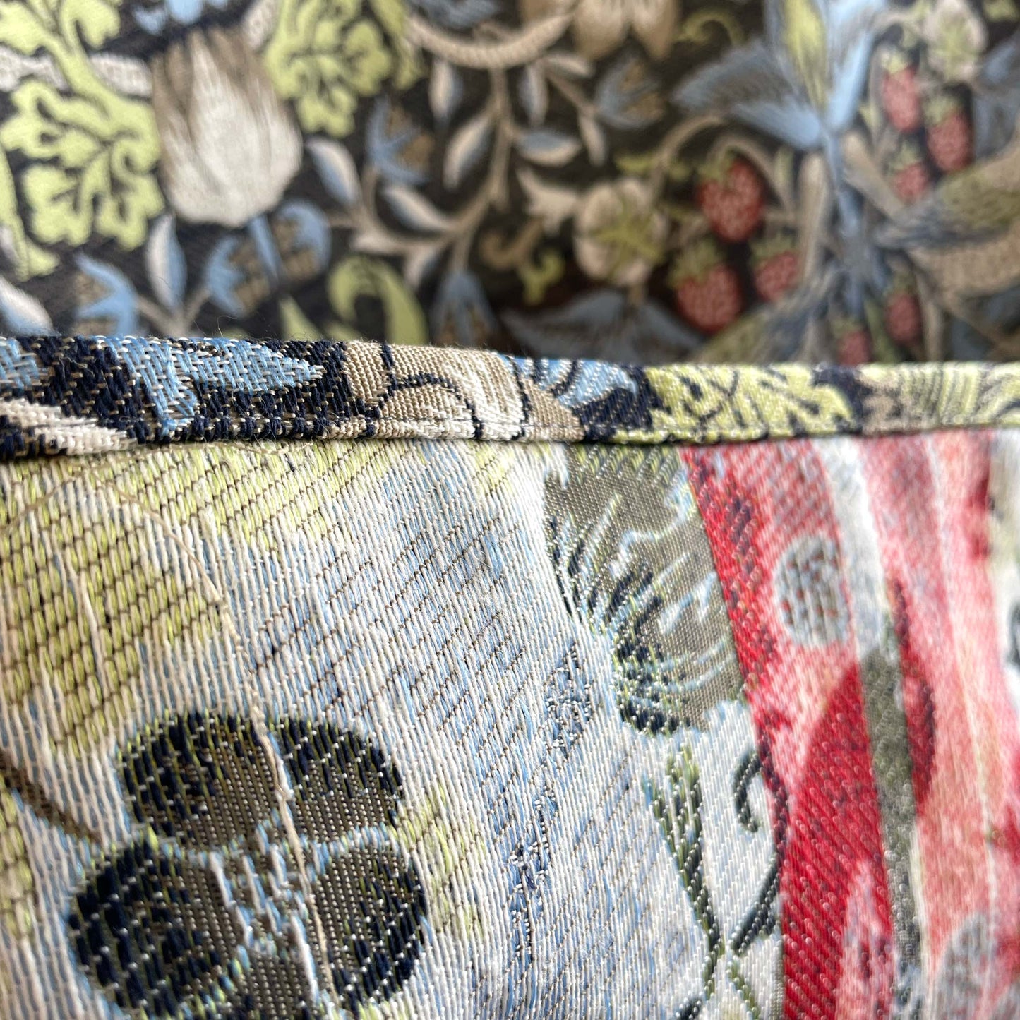 Stitched edge and corner seam of Strawberry Thief jacquard tapestry, illustrating construction quality.
