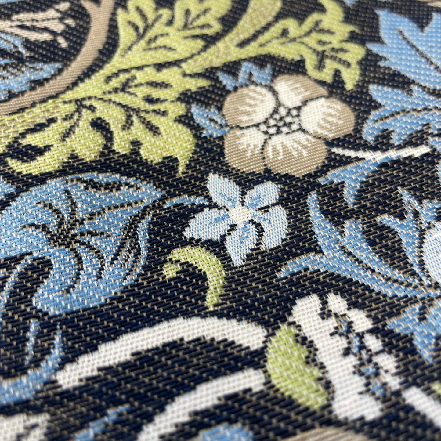 Extreme close-up of leaves and blossoms on the Strawberry Thief fabric, emphasizing jacquard texture.