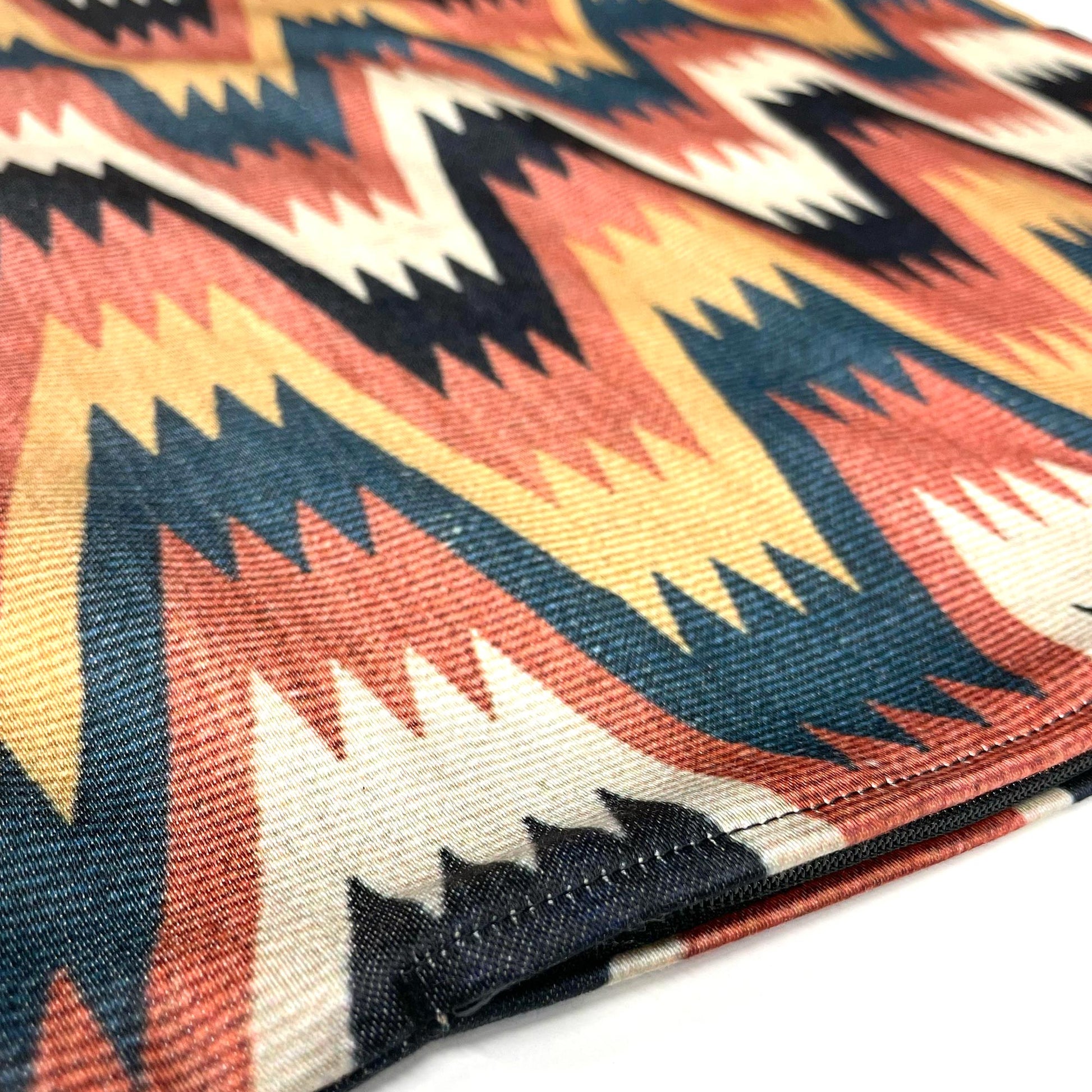 Edge of the Swedish folk zigzag cushion cover showing the hidden zipper and woven fabric texture.