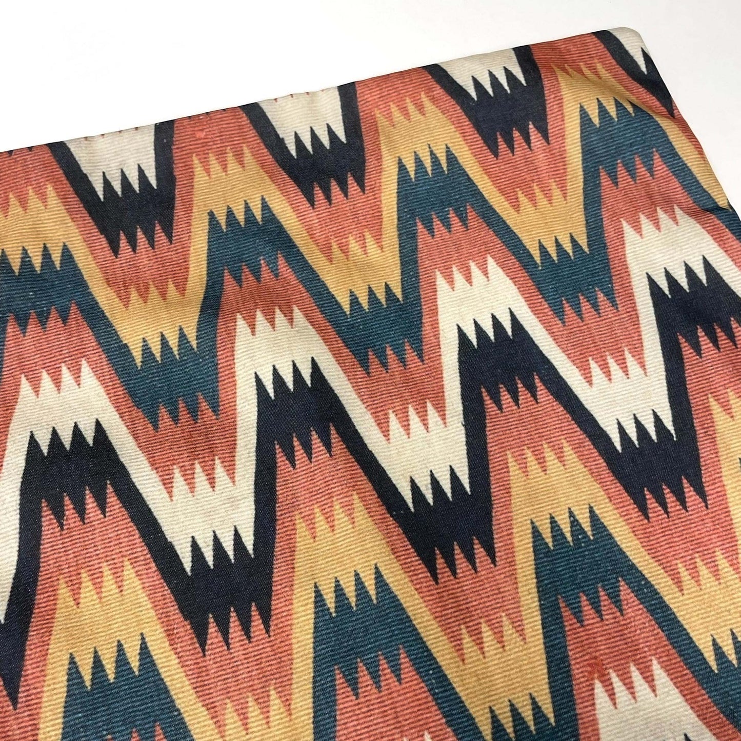 Top corner of the Swedish folk zigzag cushion cover showing the printed Lightning with Cross Border motif.