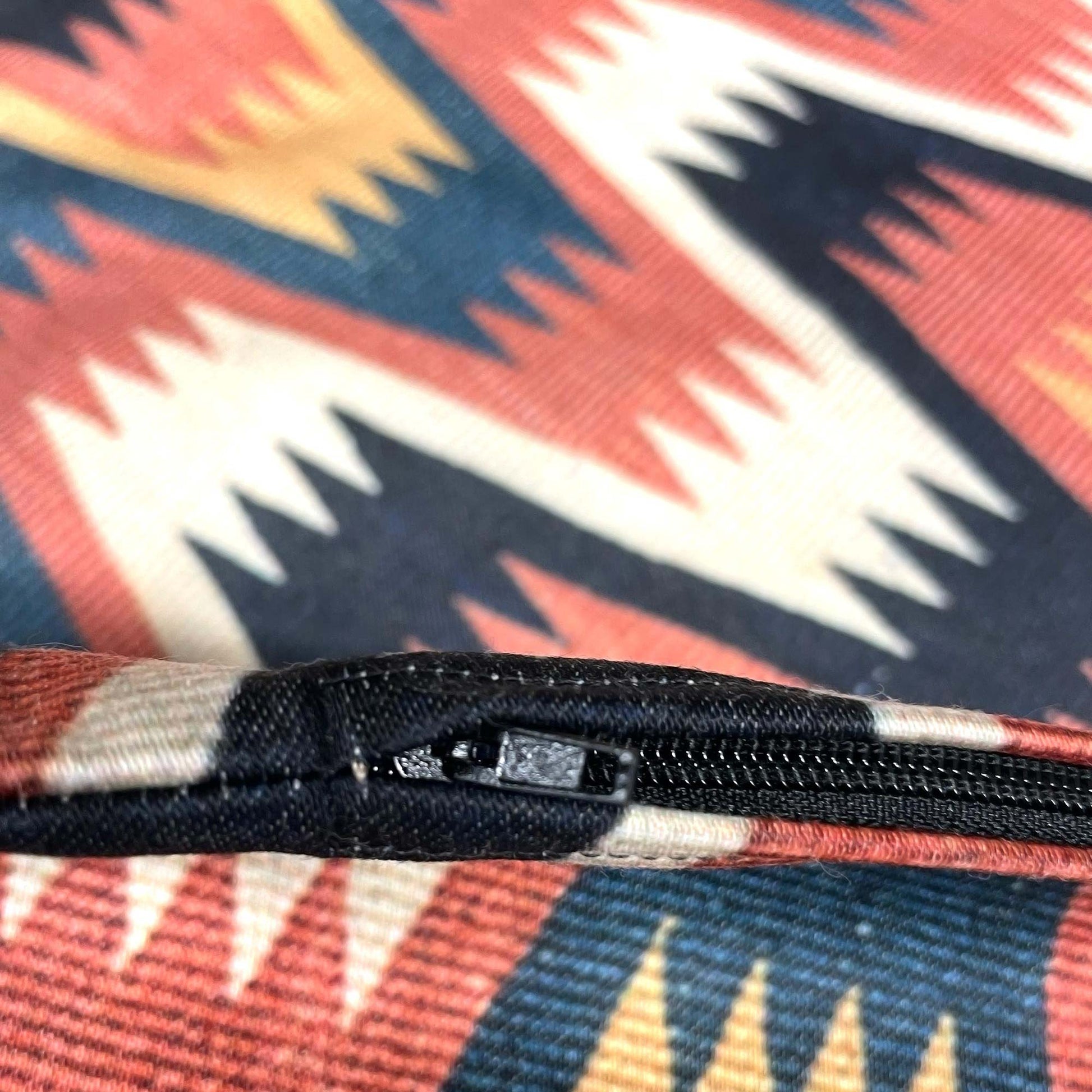 Hidden zipper hardware detail on the Swedish folk zigzag cushion cover.