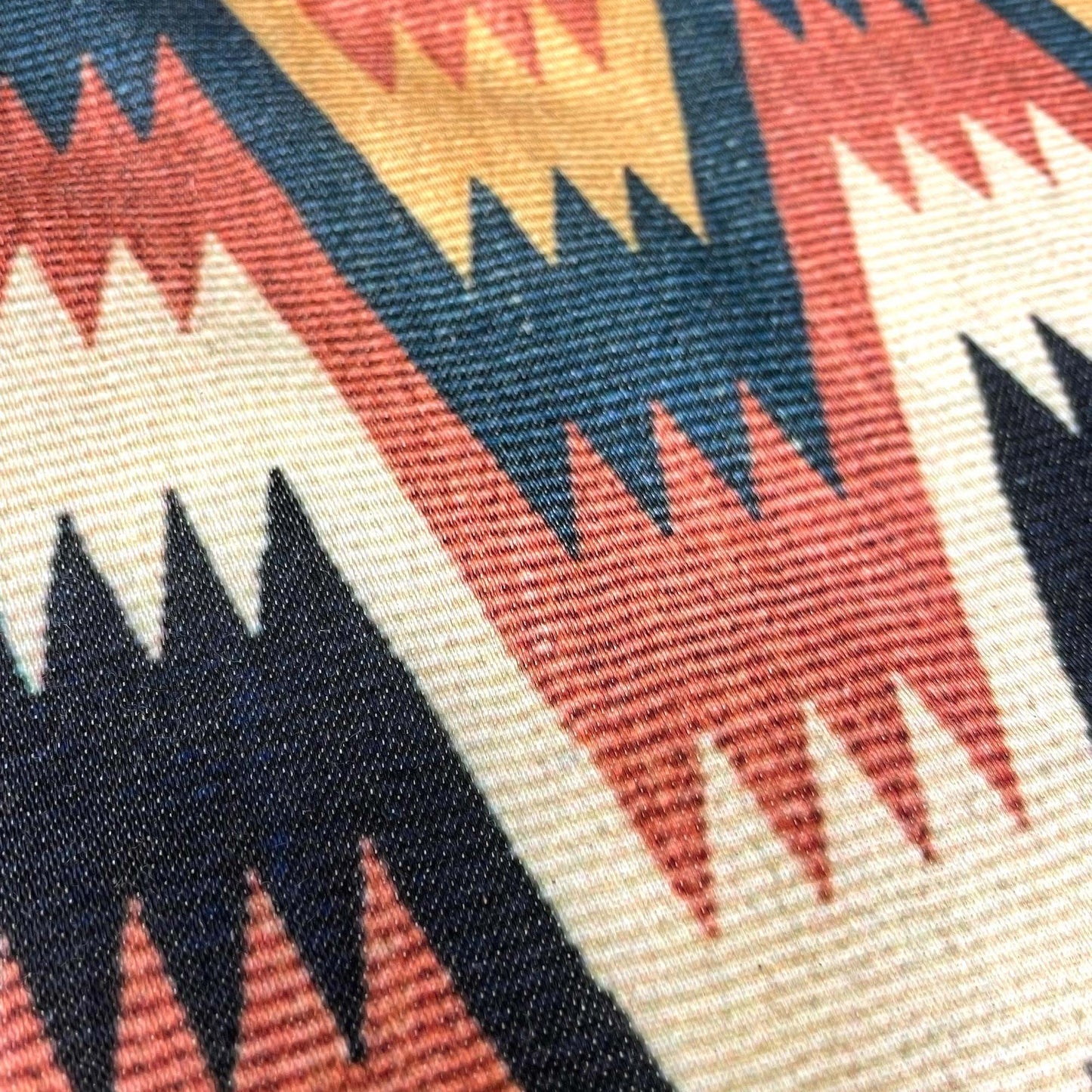 Macro of the cotton-polyester weave — design detail of the 19th-century Swedish Lightning with Cross Border motif.