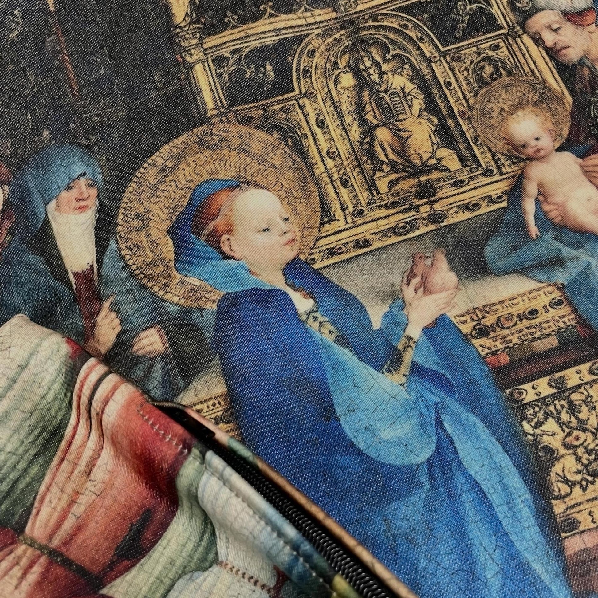 Close-up of the printed surface and stitched edge on the medieval Virgin Mary cushion cover.