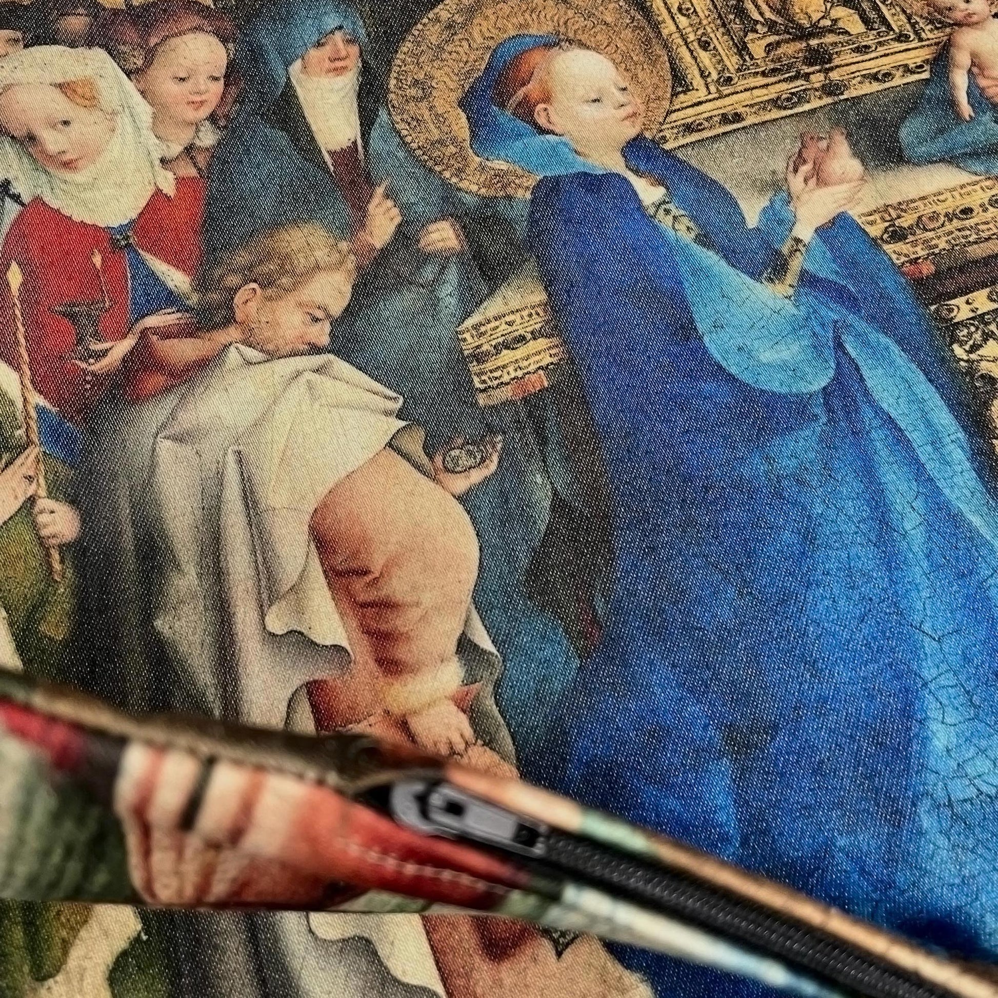 Edge and closed zipper detail of the medieval Virgin Mary cushion cover against the printed Gothic artwork.