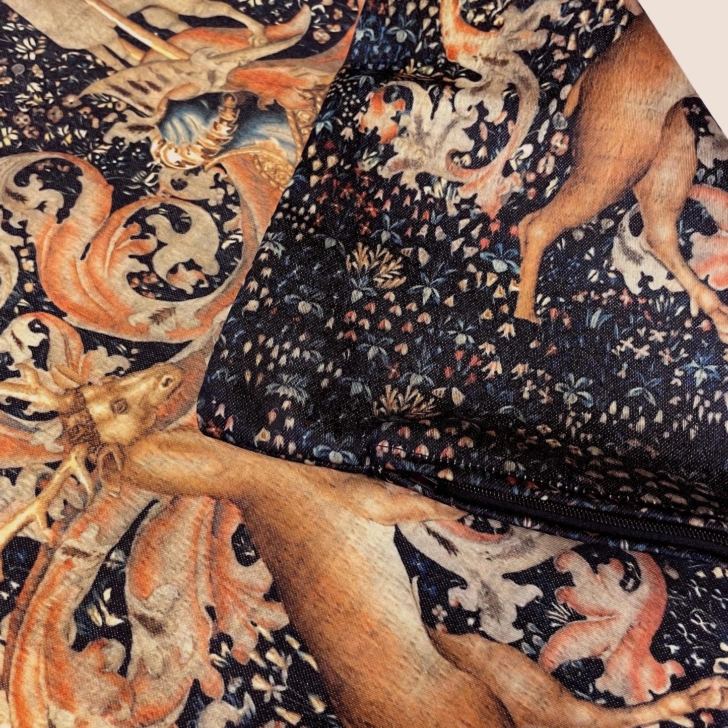 Close-up of the printed fabric and zipper closure on the Medieval Heraldry cushion cover, showing seamless finish and stag with botanical details.