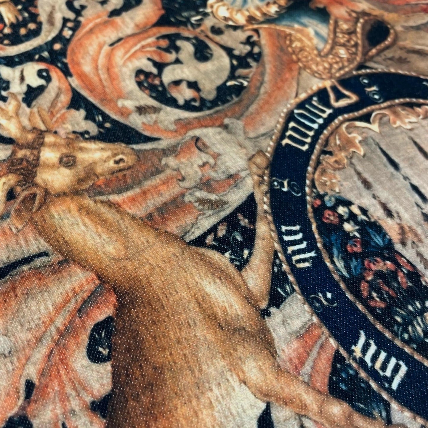 Detail of a golden stag supporting the royal crest on the Medieval Heraldry cushion cover — vibrant high-fidelity tapestry print.