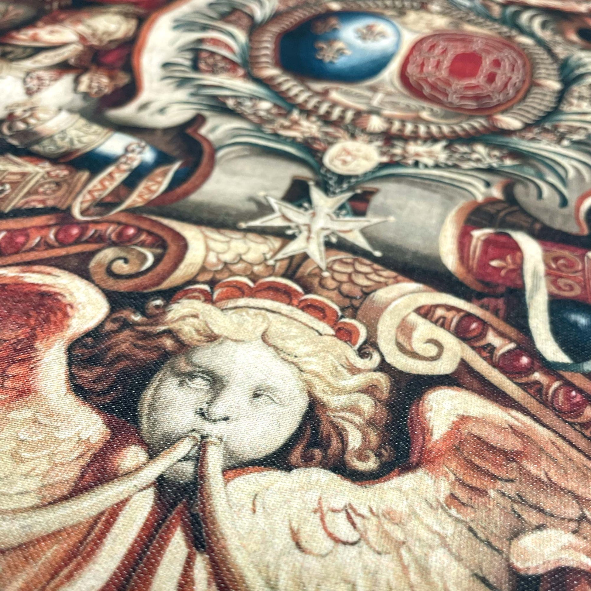 Close-up of an angelic cherub and intricate red and gold detailing — design detail from Charles Le Brun's Portière of the Chariot of Triumph.