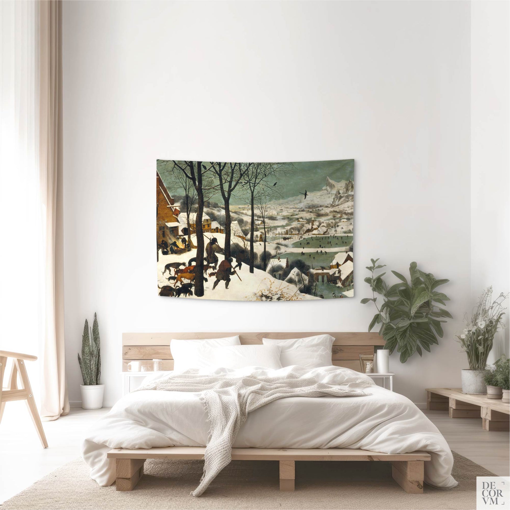 Small "Hunters in the Snow" tapestry above bed; minimalist bedroom with plants and soft neutrals, classic Bruegel winter landscape.