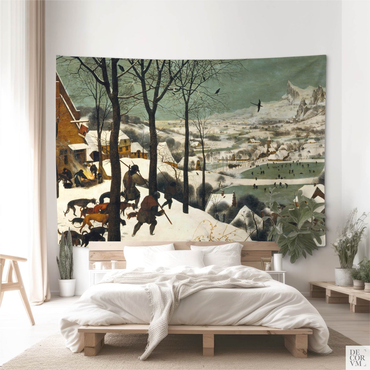 Large "Hunters in the Snow" tapestry above bed; minimalist bedroom with plants and soft neutrals, classic Bruegel winter landscape.