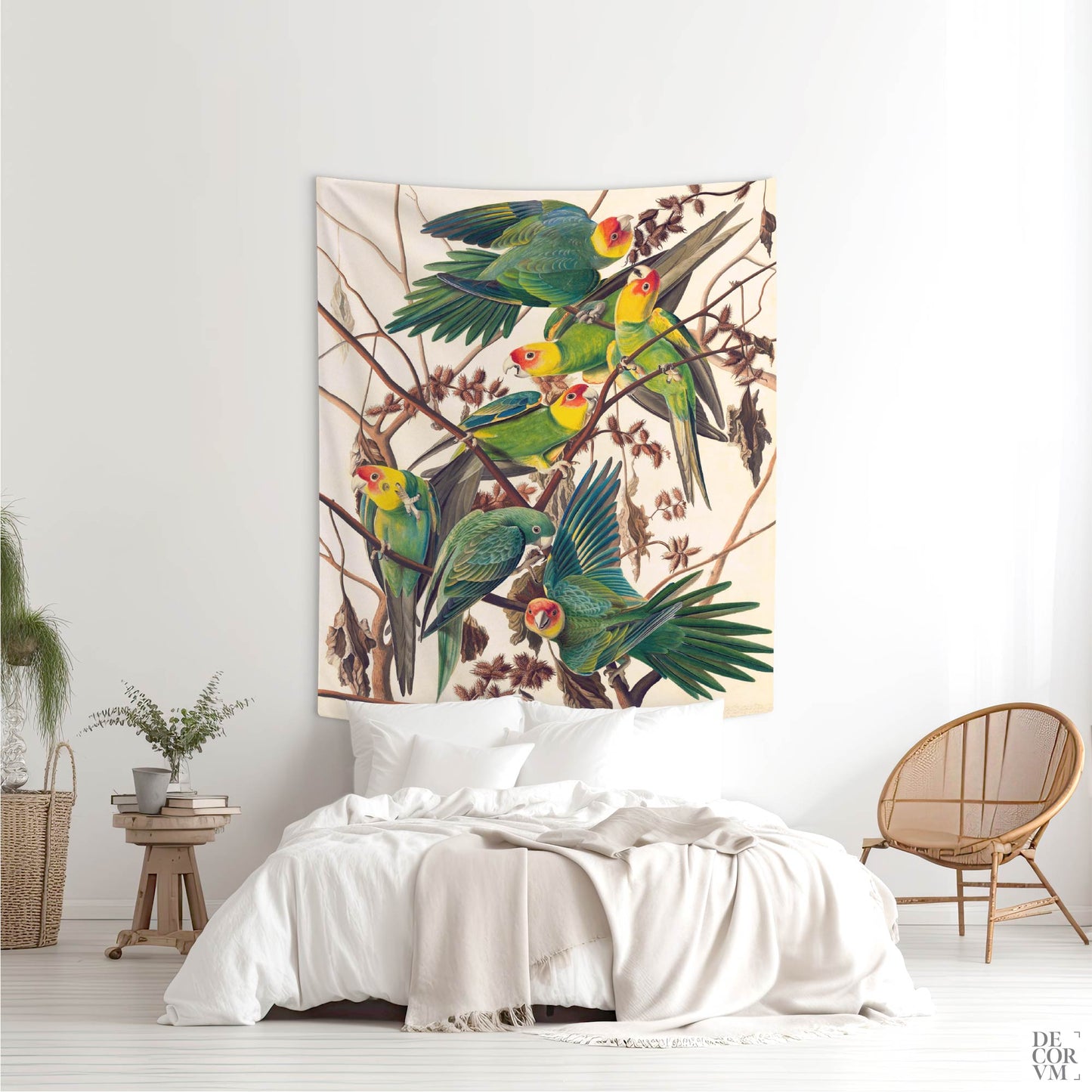 Audubon Carolina Parakeet wall tapestry above a bed with a woven rattan chair and rustic wood side table by Decorvm.
