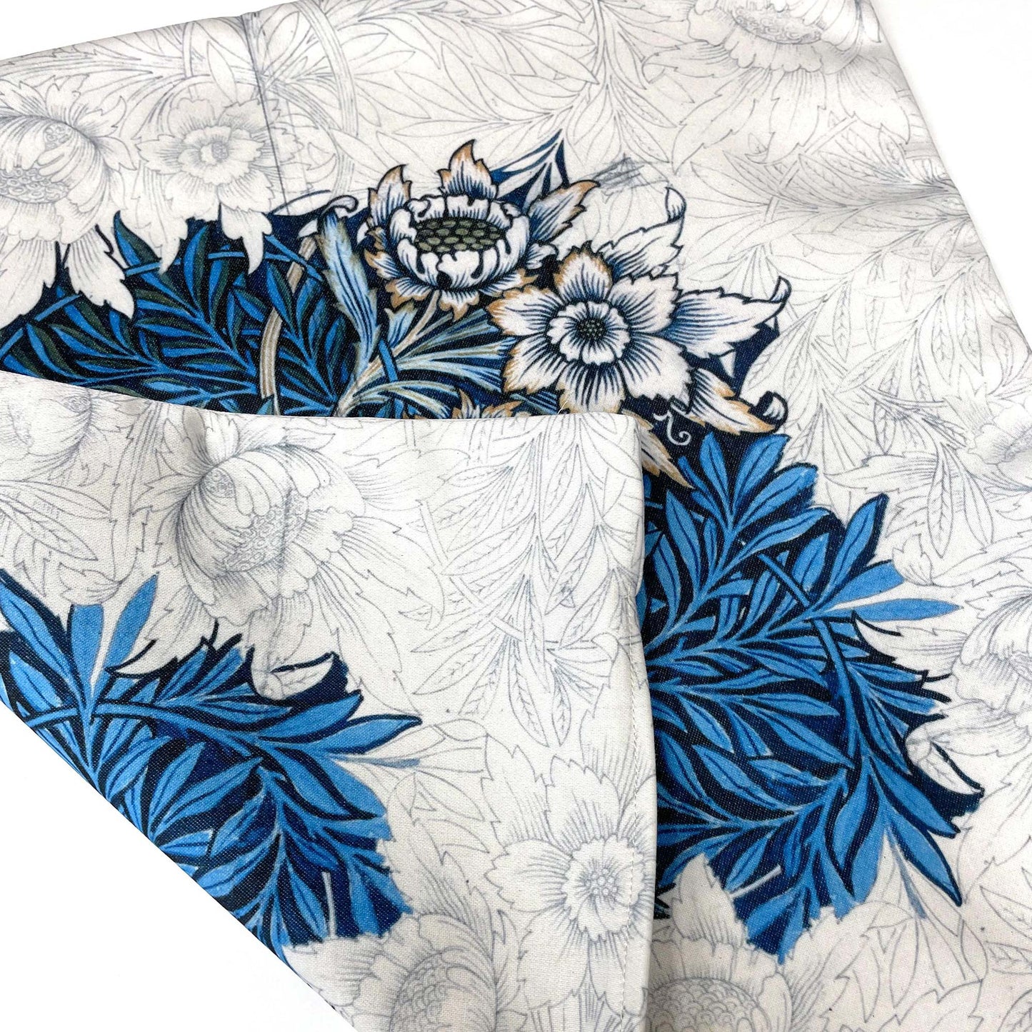 Folded William Morris Tulip and Willow pillow cover in cobalt blue, showing the fabric drape.
